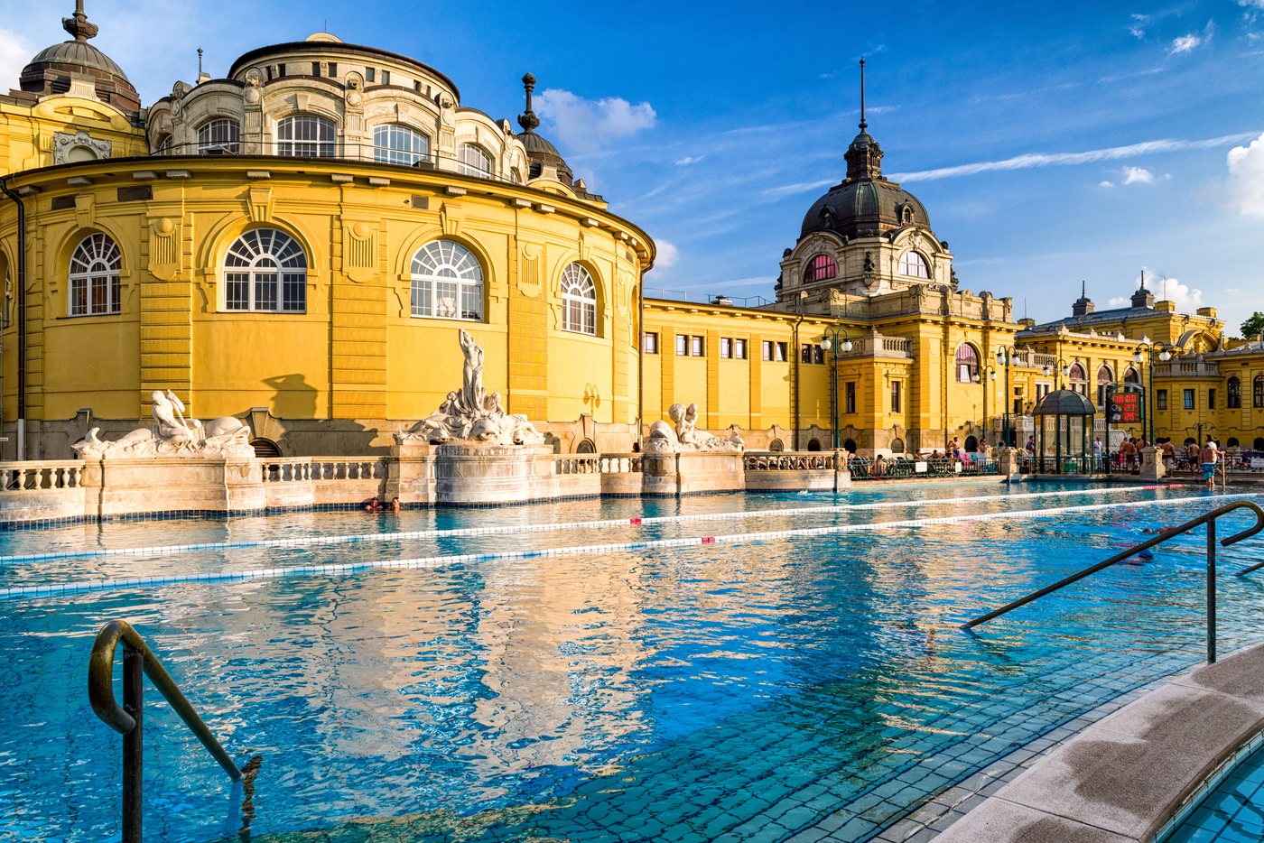 The outdoor pools of the Sz&eacute;chenyi thermal baths in Budapest, yellow neo-baroque fa&ccedil;ade.
