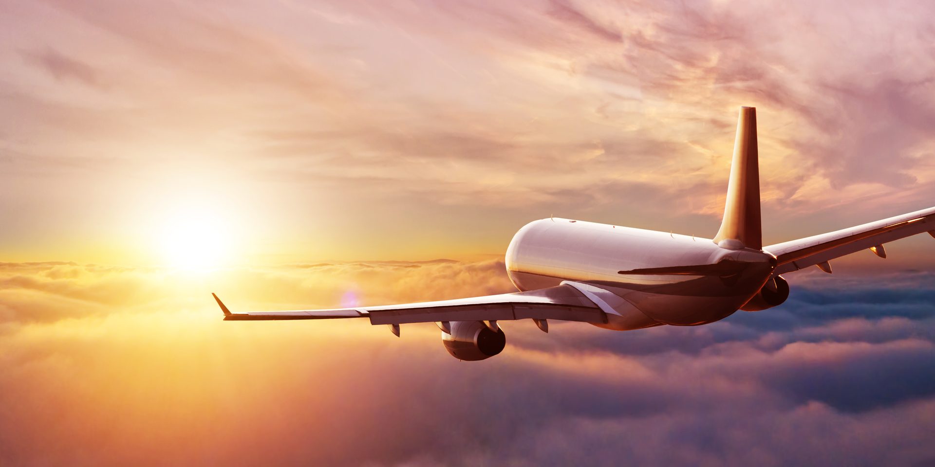 Airliner above the clouds at sunset.